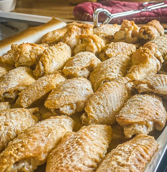 Chicken wings halfway through baking