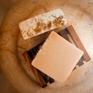 chamomile and tallow soap from prairie rose farmstead sitting on a wooden soap dish